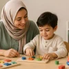 A mother chooses the right playpen for her child using a simple test based on age and skill.